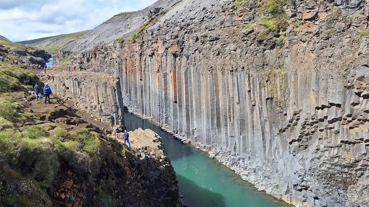 A 4x4 parked above the basalt walls of Stuðlagil Canyon in East Iceland, the private option among Seyðisfjörður tours from the cruise port